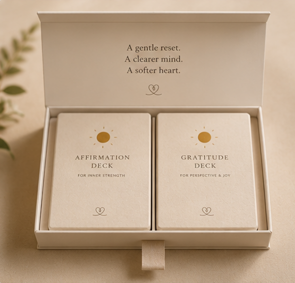 Two card decks in a box with text about affirmation and gratitude on a neutral background.