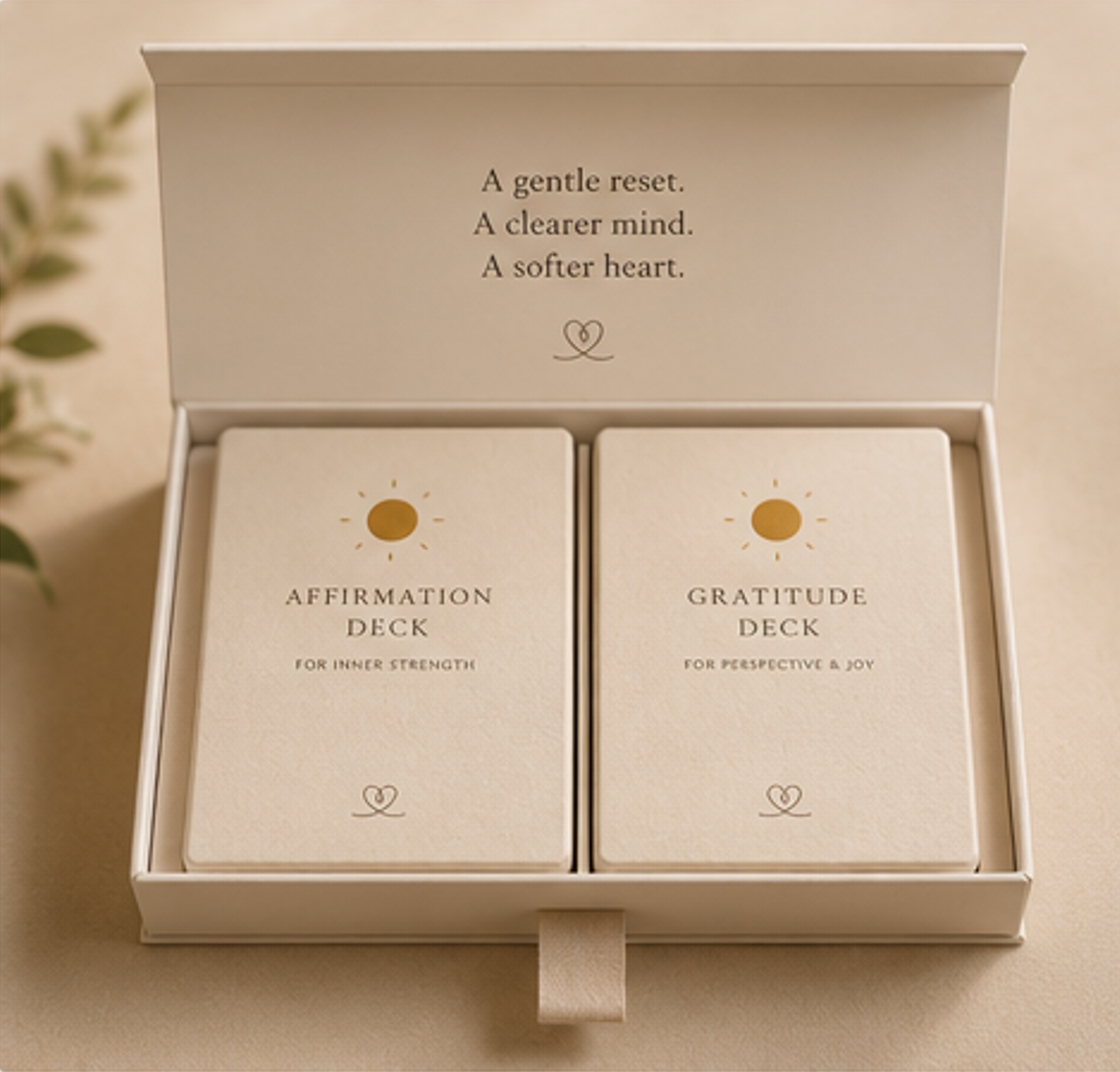Two card decks in a box with text about affirmation and gratitude on a neutral background.